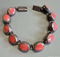 Bracelet in circular form showing coral cabochons and clasp