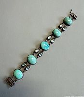 full view of bracelet laid flat showing stones and clasp