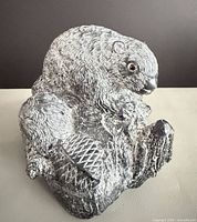 Front angled view of beaver figurine showing overall form and texture