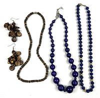 All four jewelry pieces laid out: brown bead necklace and earrings, two purple bead necklaces