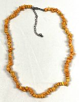 Full view of orange stone chip necklace with extender