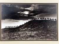 Full view of framed photo print with riders silhouetted on ridge