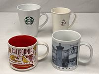 Group shot of four Starbucks mugs