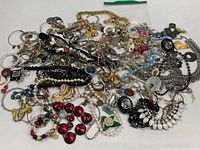 Overall view of entire pile showing variety of costume jewelry pieces