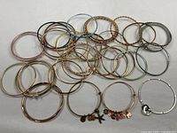 All bracelets laid out showing variety of bangles and charm styles