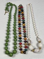 Full view of all three necklaces laid side by side