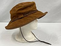 Profile view of suede Outback hat on mannequin showing brim shape and chin cord