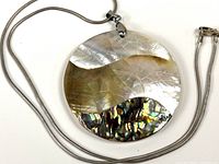 Front view of shell pendant on sterling snake chain