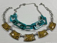 Both necklaces laid flat showing overall designs and lengths