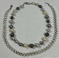 Both necklaces laid flat to show full design and clasps