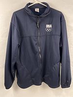 Front view of navy blue Team USA Olympic track jacket