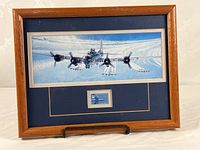 Full view of framed display showing artwork and stamp