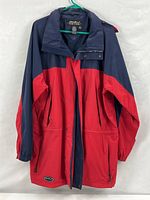Front view of two-tone navy/red hooded parka on hanger