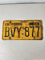 Front view showing full plate, number BVY 877, colors, rust, 1956 tab