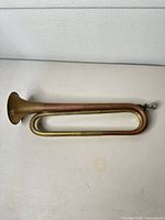 Full view of brass bugle showing overall form and patina