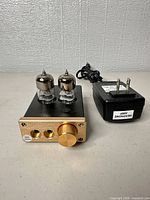 Front view of amplifier with tubes and power adapter