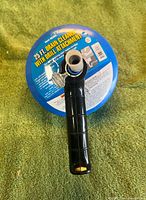 Top view of blue drum auger showing label and handle