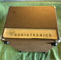 Brown vinyl covered exterior with Audiotronics badge and metal corner protectors