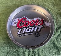 front view of round Coors Light tray showing full logo and wear around rim