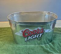 Front view showing Coors Light logo and oval shape
