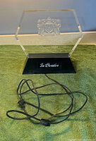 Front view showing entire sign, acrylic panel, base, and power cord