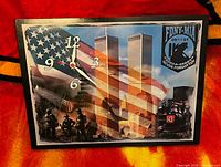 Front view showing clock face with 9/11 imagery, numerals and hands