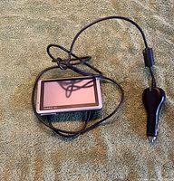 Front view of Garmin Nuvi 1350 GPS with attached car charger cable