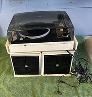 full view of turntable with lid and two speakers