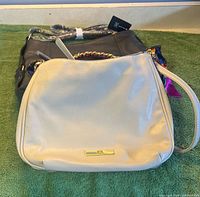 Front view of both purses showing colours, shapes, hardware