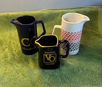 Front view of all three pitchers on towel
