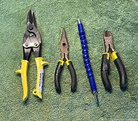 group shot of all four hand tools on green background