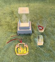 Group view of all five items: pedestal with acrylic insert, crystal block, ornament, shot glass