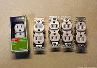 Front view: one boxed outlet and four loose outlets showing white faces