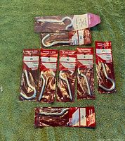 All eight packaged screw hooks on surface
