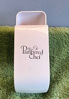 Front view showing Pampered Chef logo on white measuring cup