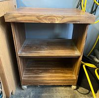 Front view of rolling cart showing shelves and casters