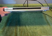 Top and front view of the Sony DVP-NS575P unit with power cord