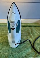 Front view of Sunbeam Steam Master LX iron showing pointed soleplate, control dial, cord