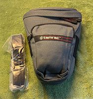 Front view of Tamrac holster bag and sealed shoulder strap