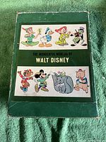Front of green slipcase with Disney character art