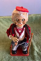 Front view showing toy details: cigar, cane, clothing, base