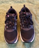 Top view of both sneakers showing size, laces, mesh uppers