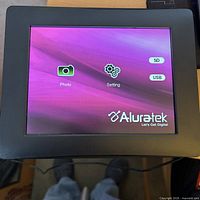 Front view, powered on showing Aluratek start screen