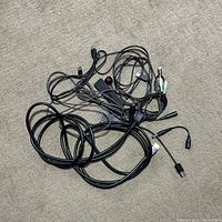 Overview of bundled cables and adapters on carpet
