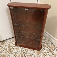 Front view showing glass doors and interior shelves