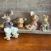 All four bunny figurines lined up for scale and variety