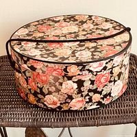 Closed floral hat box on chair