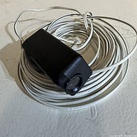 Close view of one sensor housing with coiled cable