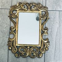 Full view of mirror showing ornate gold frame