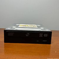 Front view of HP TS-H653 optical drive bezel and logos